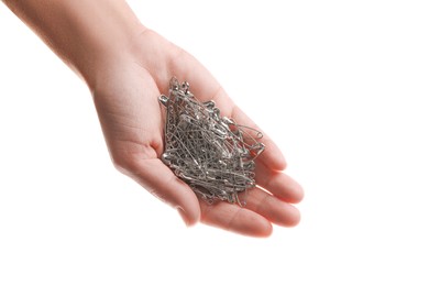 Woman holding pile of safety pins on white background, closeup