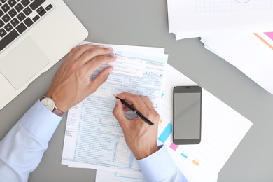 Tax accountant working with documents at table