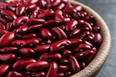 Photo of Raw red kidney beans in wooden bowl, closeup