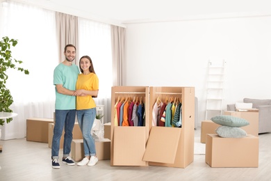 Photo of Young couple near wardrobe boxes at home