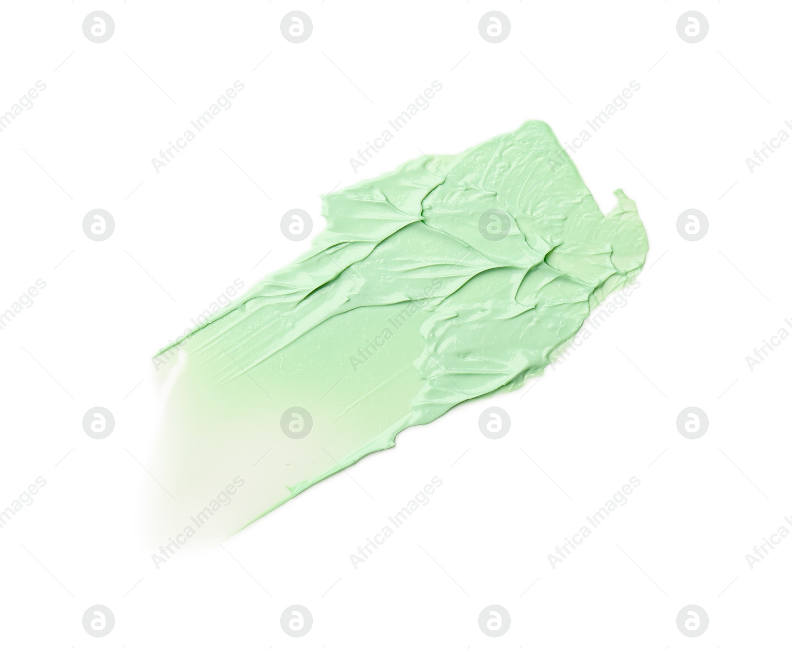 Photo of Strokes of green color correcting concealer isolated on white, top view