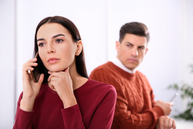 Photo of Unhappy couple with relationship problems in room