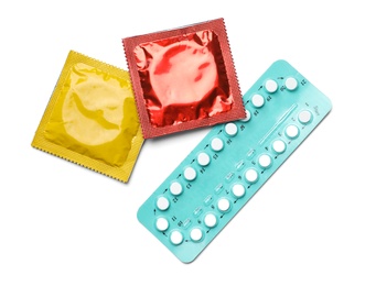 Photo of Condoms and birth control pills on white background, top view. Safe sex concept