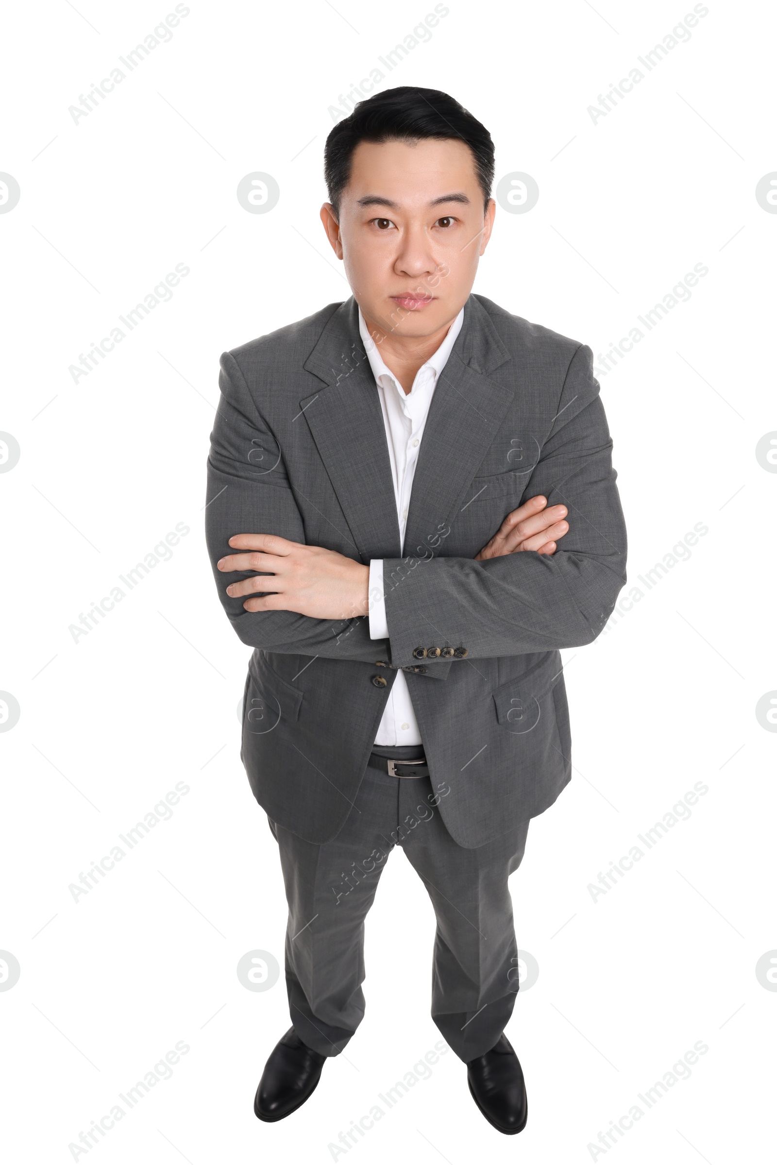 Photo of Businessman in suit posing on white background, above view