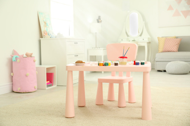 Pink children's table for painting in room