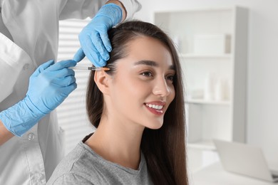 Trichologist giving injection to patient in clinic, closeup