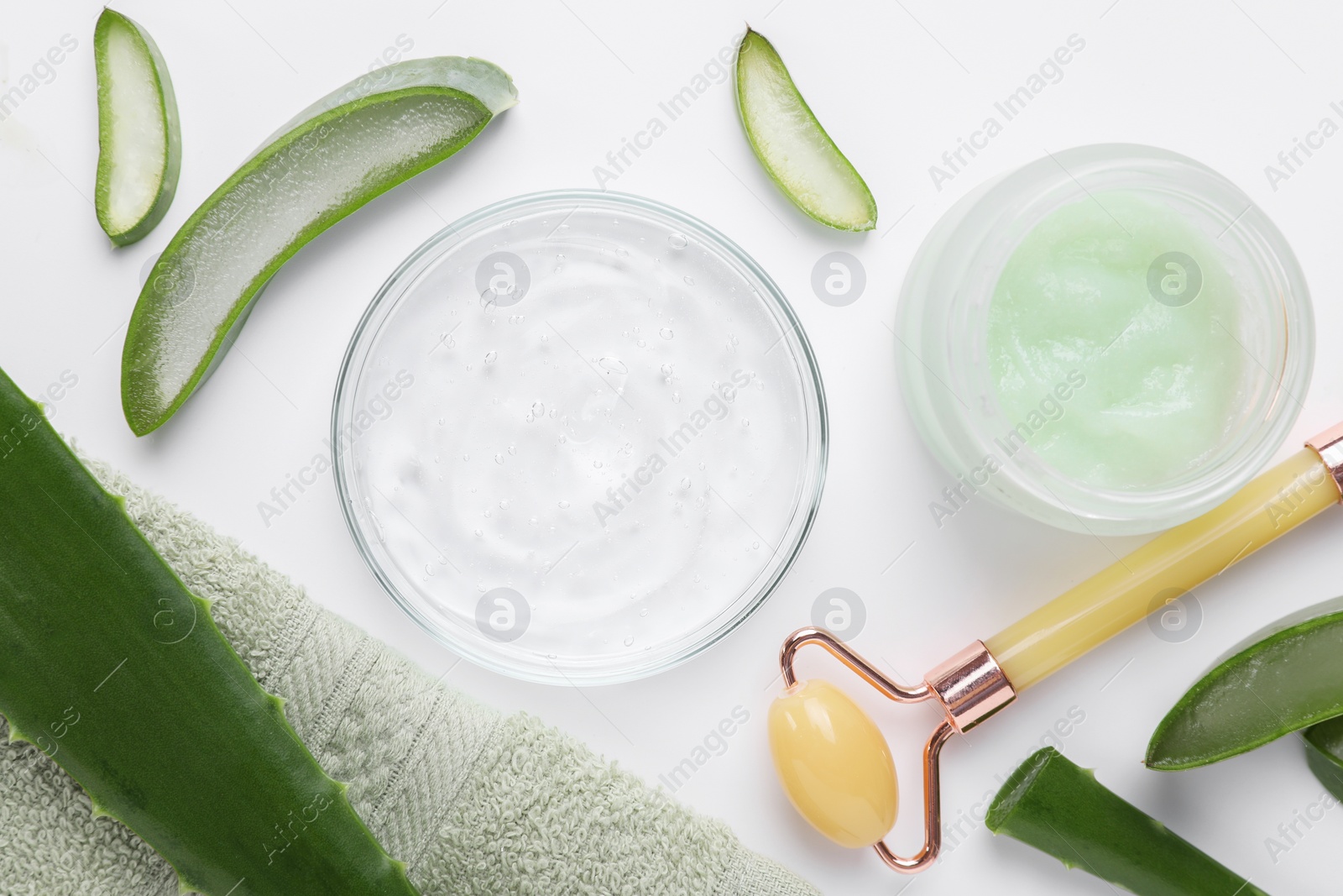 Photo of Flat lay composition with cosmetic products and cut aloe leaves on white background