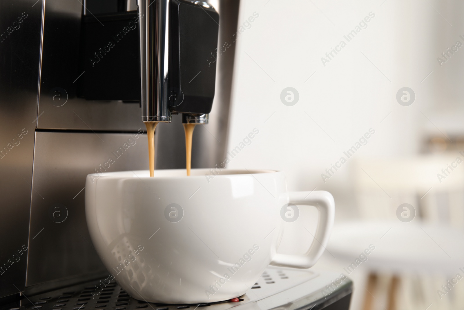 Photo of Espresso machine pouring coffee into cup against blurred background, closeup. Space for text
