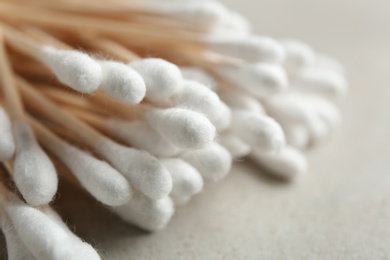 Photo of Pile of cotton swabs on grey background, closeup. Space for text