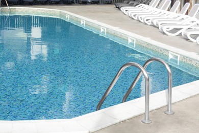 Photo of Ladder with grab bars in outdoor swimming pool