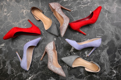 Photo of Different female shoes on marble background