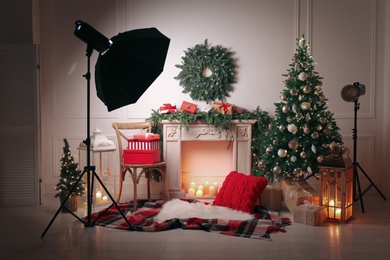 Beautiful Christmas themed photo zone with professional equipment and fireplace