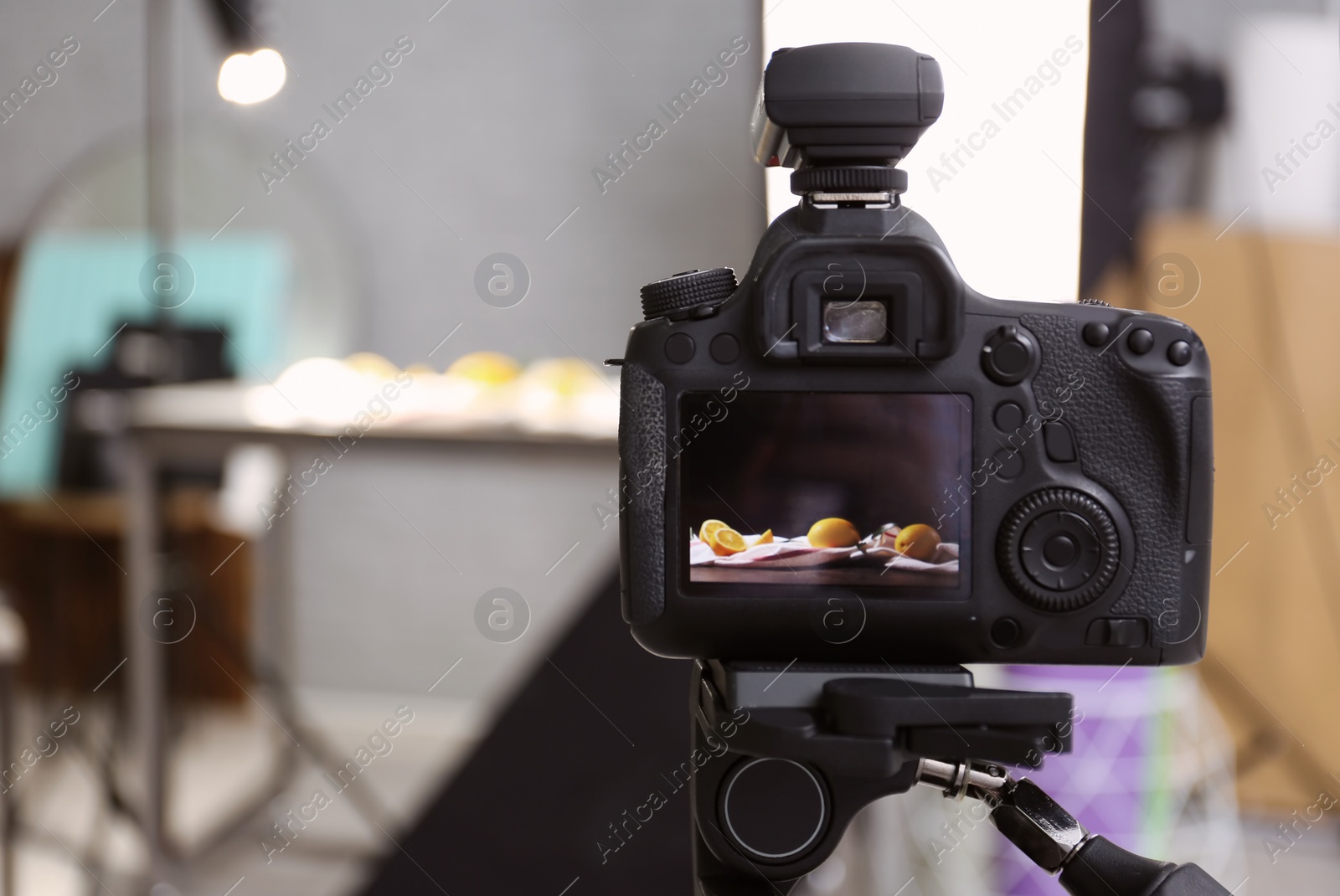 Photo of Professional camera on tripod in studio, closeup. Food photography