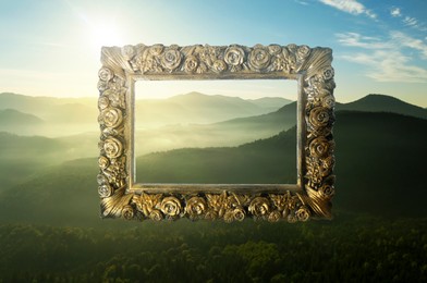 Image of Vintage frame and beautiful mountains with fog in morning