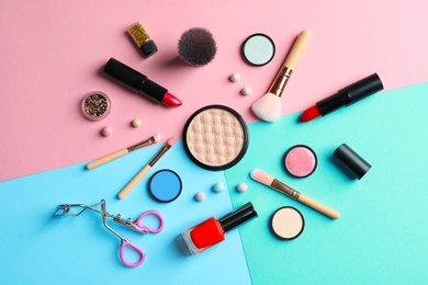 Photo of Flat lay composition with decorative cosmetics on color background