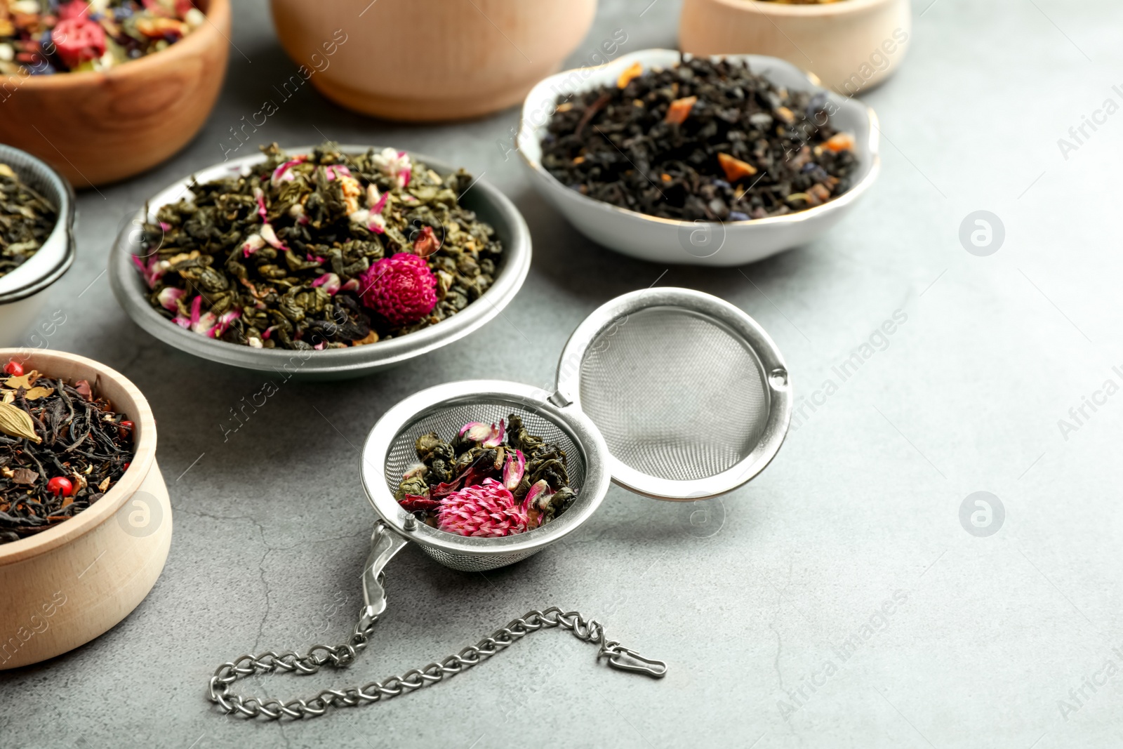 Photo of Many different herbal teas on grey table