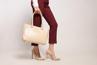 Photo of Young woman with stylish bag on white background, closeup