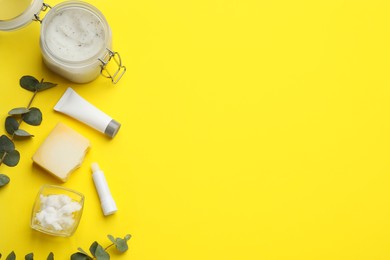 Photo of Flat lay composition with beeswax cosmetics on yellow background. Space for text