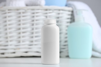 Bottle of dusting powder on white table. Baby cosmetic product