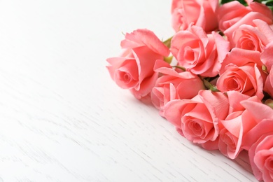 Beautiful roses on wooden table