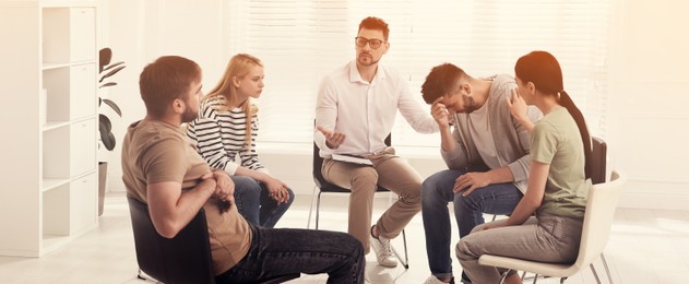 Image of Psychotherapist working with group of drug addicted people at therapy session indoors. Banner design