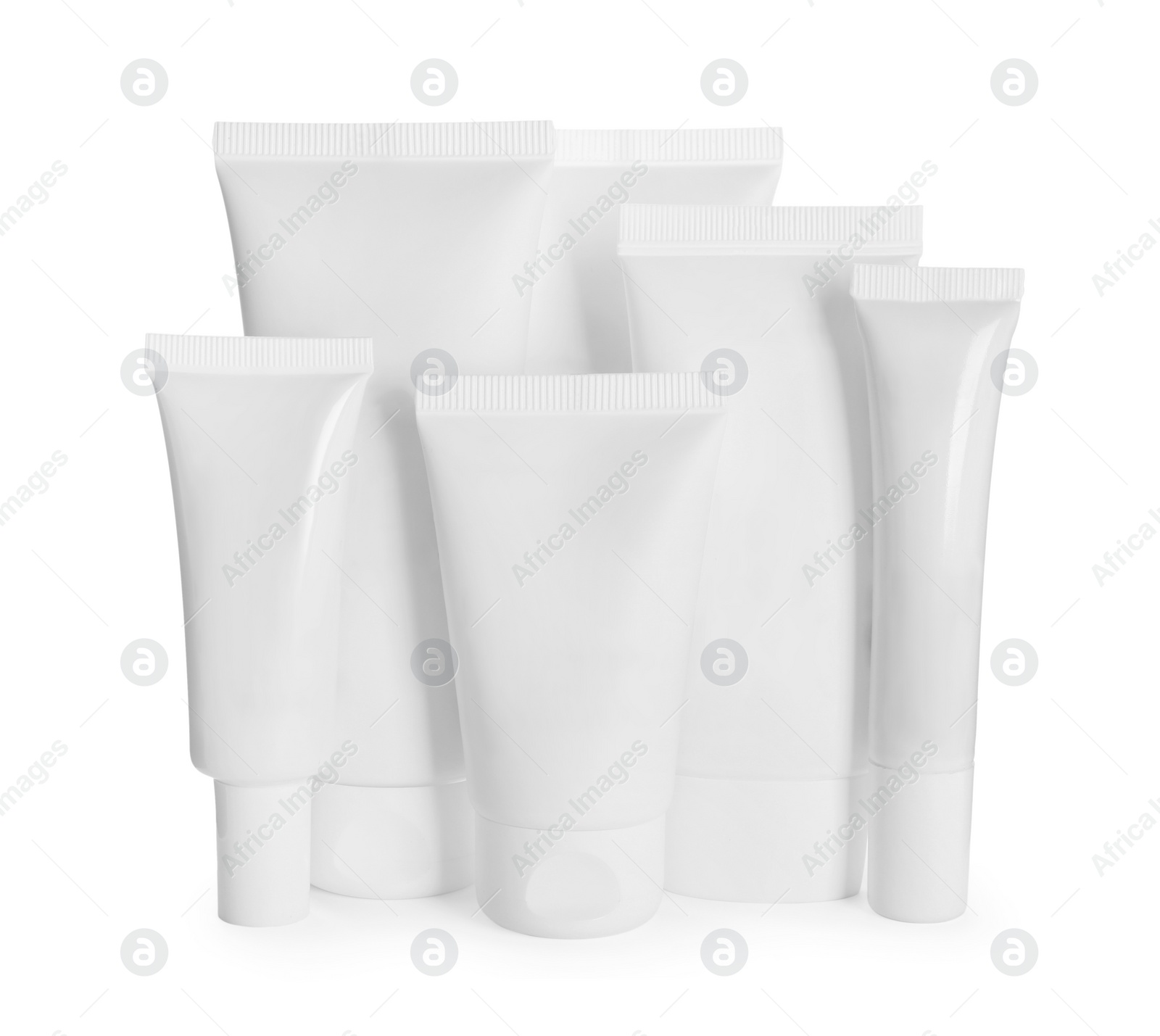 Photo of Blank tubes and jars of cosmetic products on white background