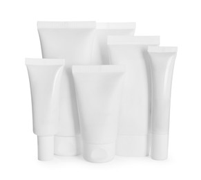 Photo of Blank tubes and jars of cosmetic products on white background