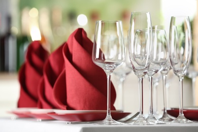 Photo of Table setting with empty glasses, plates and cutlery on table