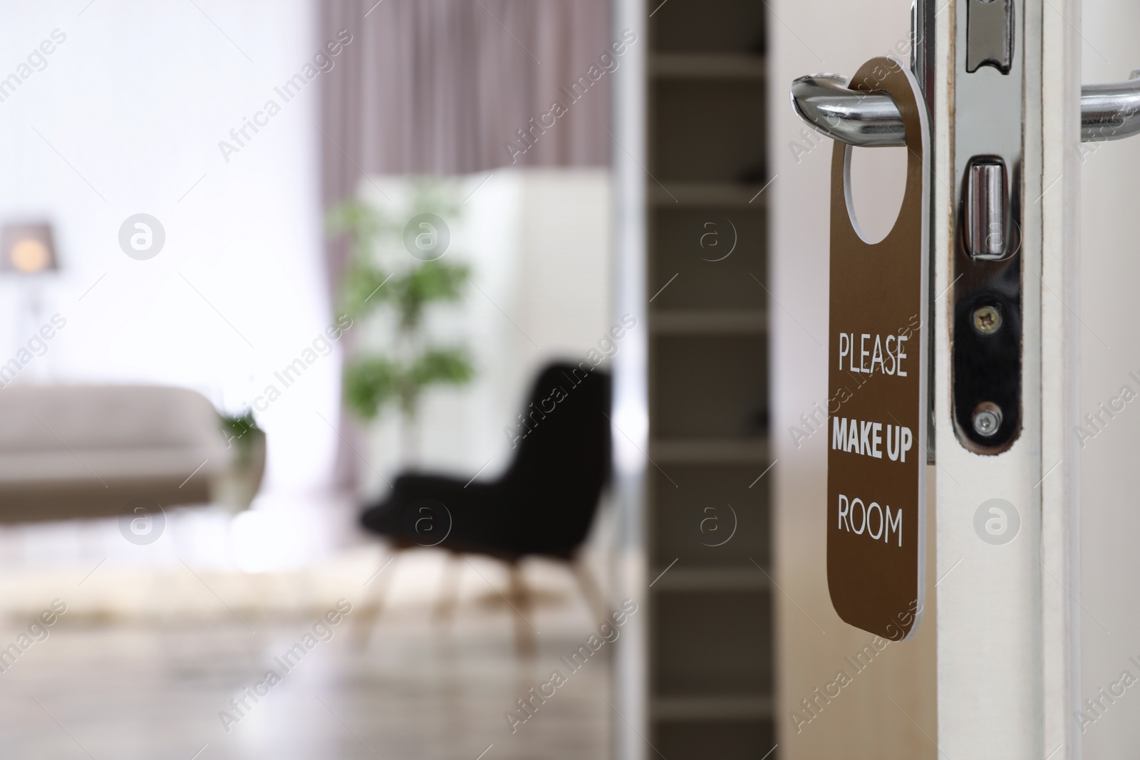 Photo of Open door with sign PLEASE MAKE UP ROOM on handle at hotel, space for text