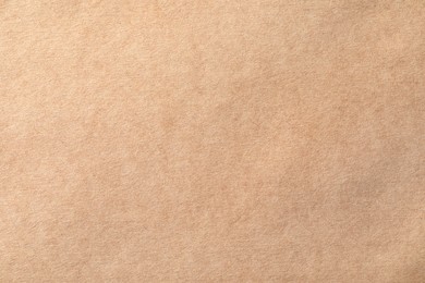Photo of Texture of kraft paper sheet as background, closeup