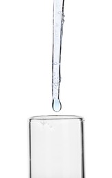Photo of Dripping liquid from pipette into test tube isolated on white, closeup