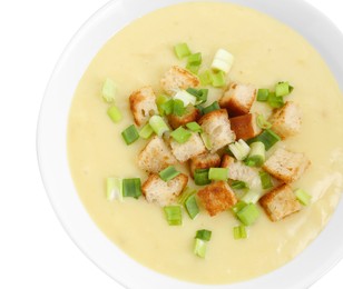 Photo of Tasty potato soup with croutons and green onion in bowl isolated on white, top view