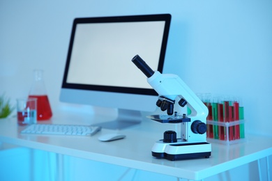 Photo of Workplace with computer and microscope for medical student in scientific laboratory