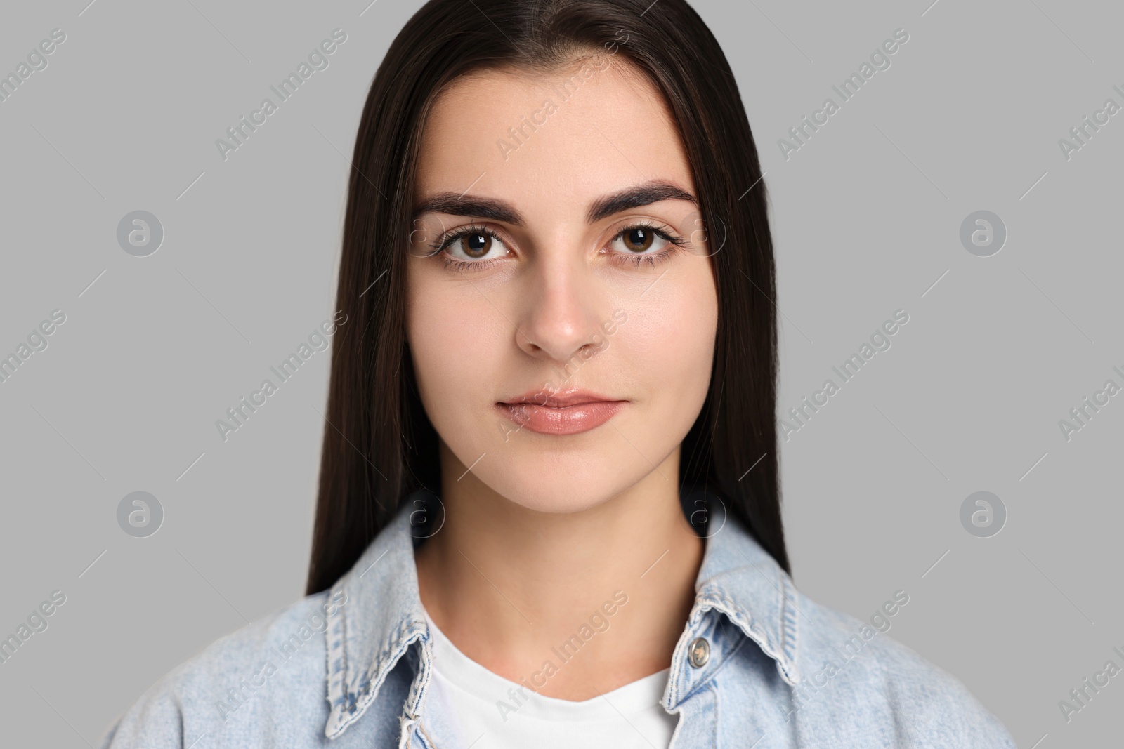 Photo of Portrait of beautiful woman on grey background