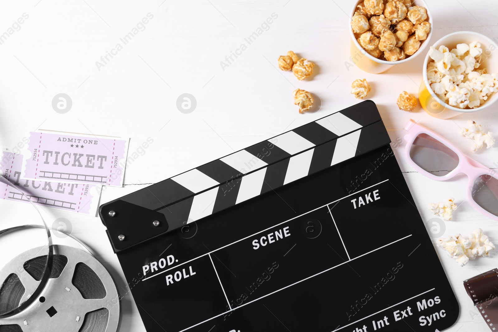 Photo of Flat lay composition with clapperboard and popcorn on white wooden table