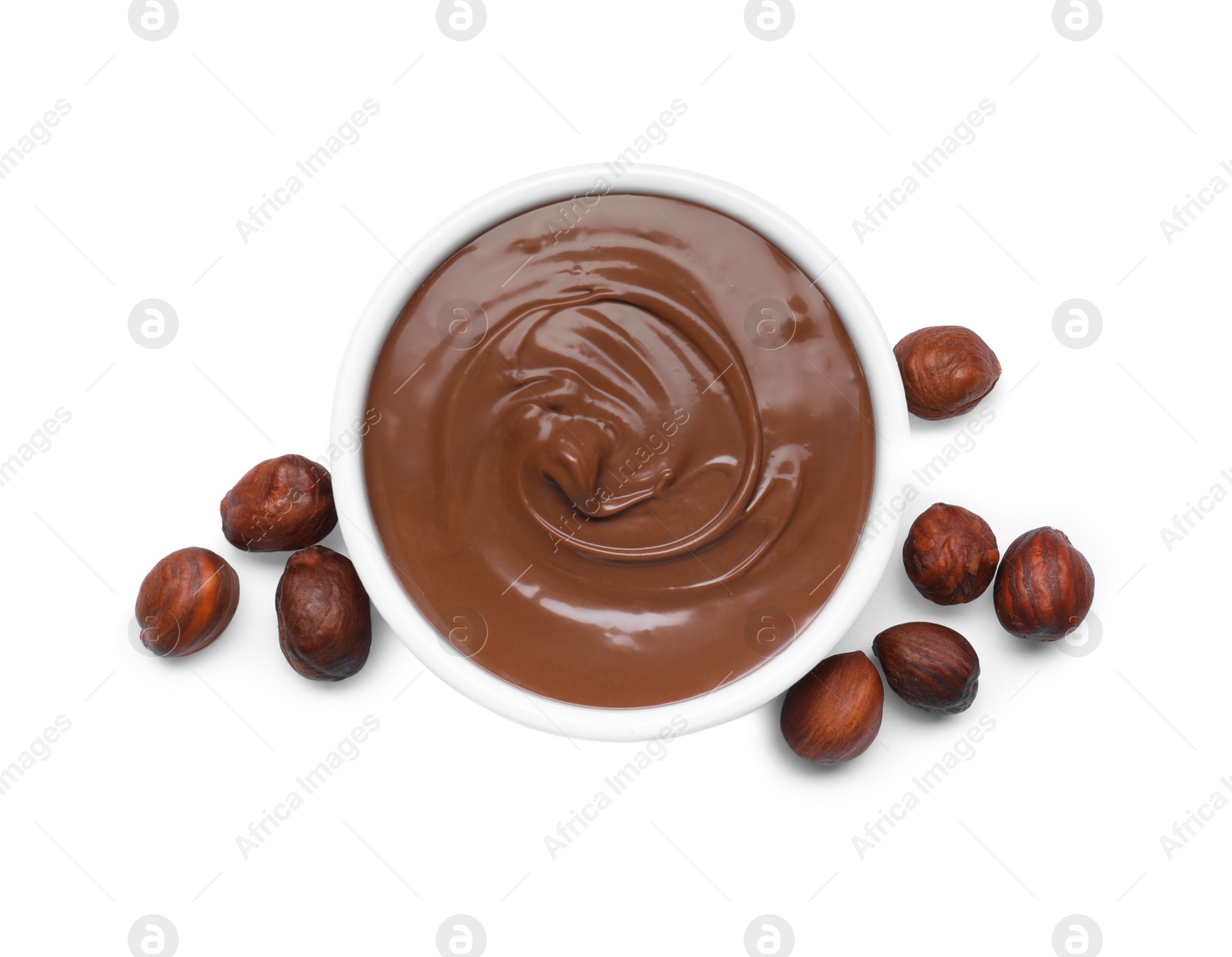 Photo of Bowl with tasty chocolate paste and nuts isolated on white, top view