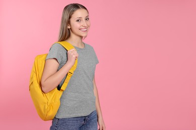 Photo of Teenage girl with backpack on pink background. Space for text