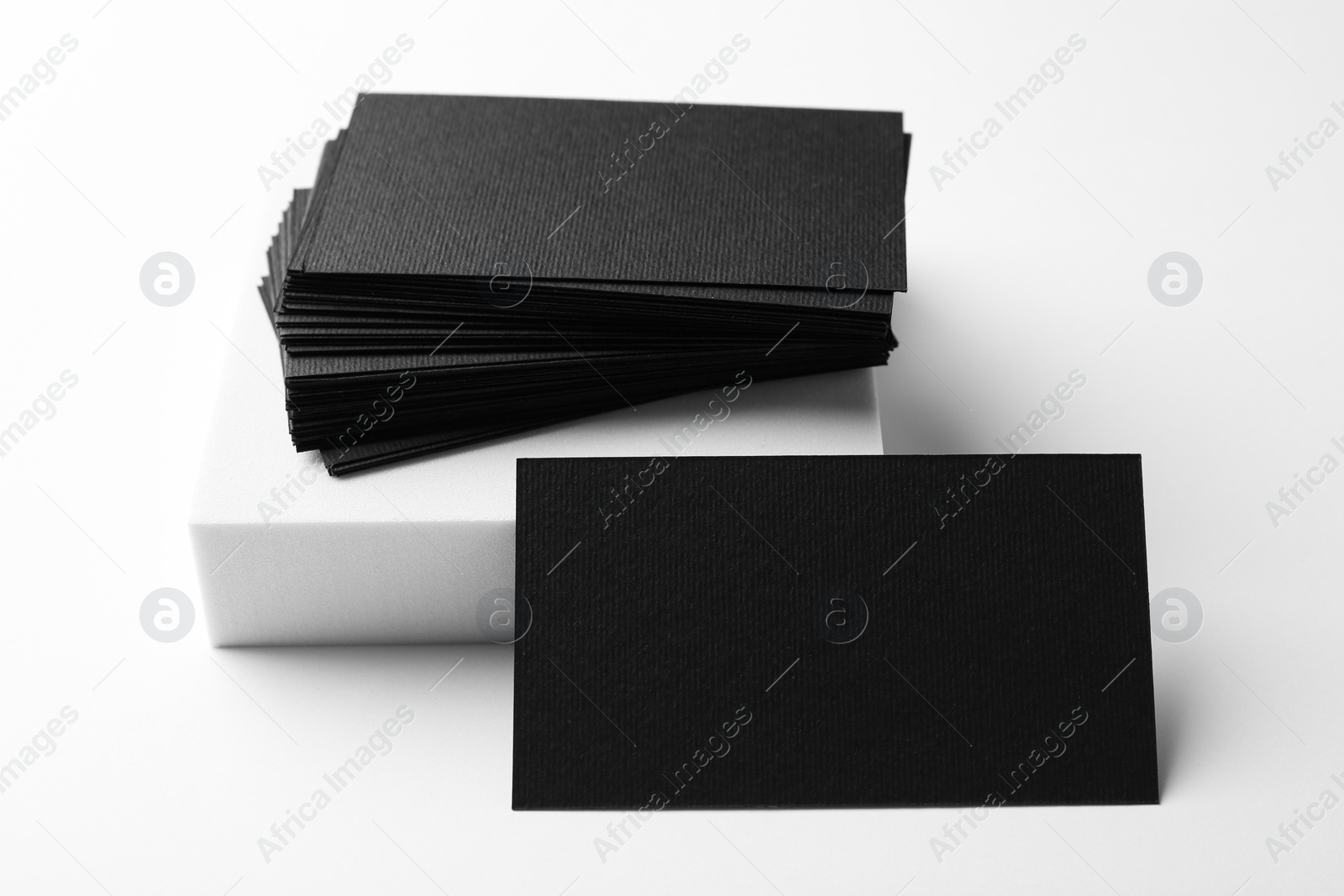 Photo of Blank black business cards on white background. Mockup for design