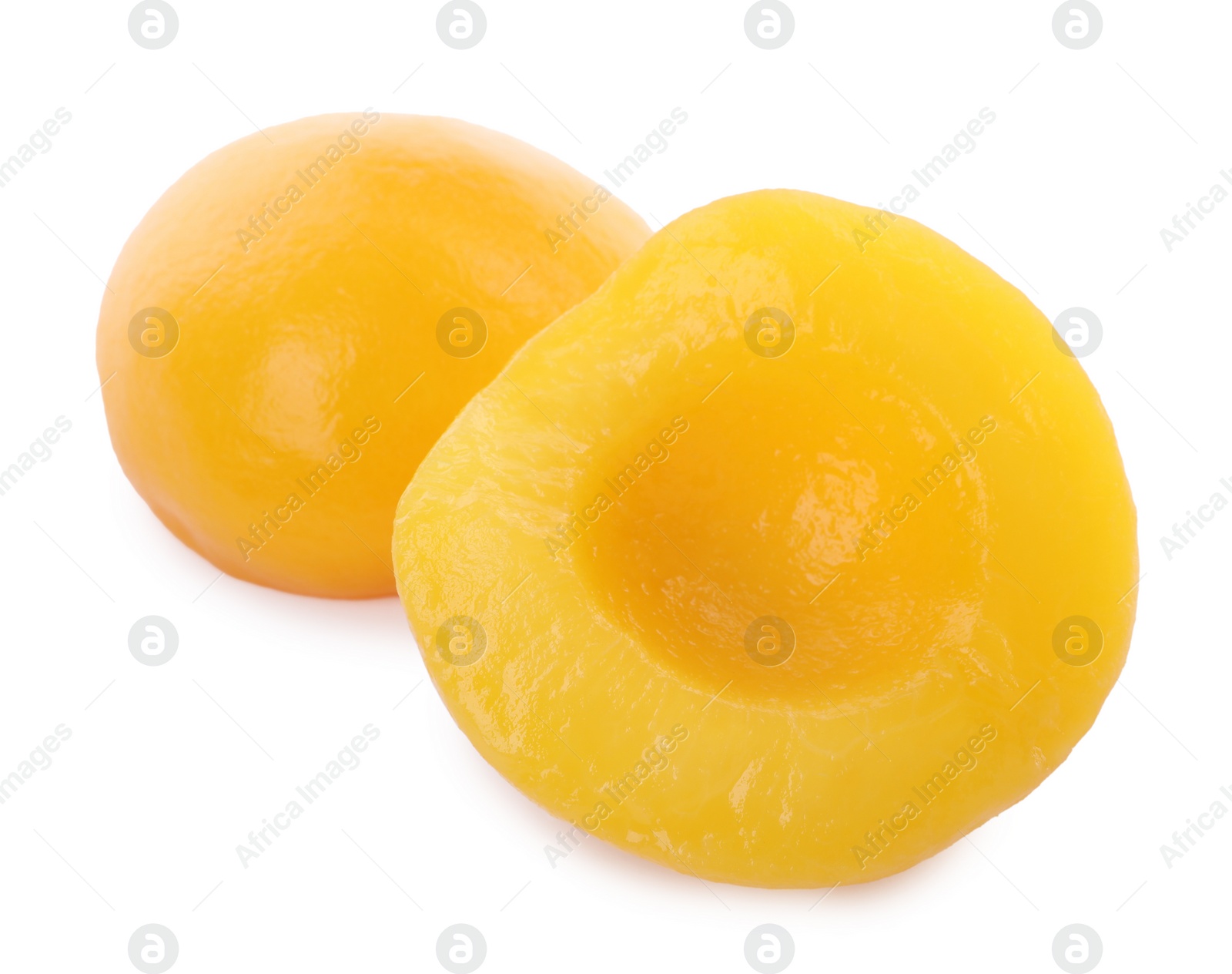 Photo of Sweet juicy canned peach halves isolated on white