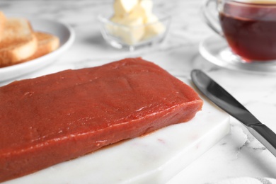 Photo of Quince paste for breakfast on white table, closeup