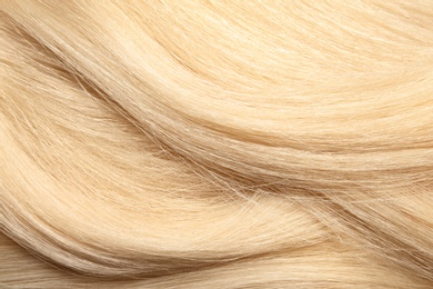 Photo of Texture of healthy blond hair as background, closeup