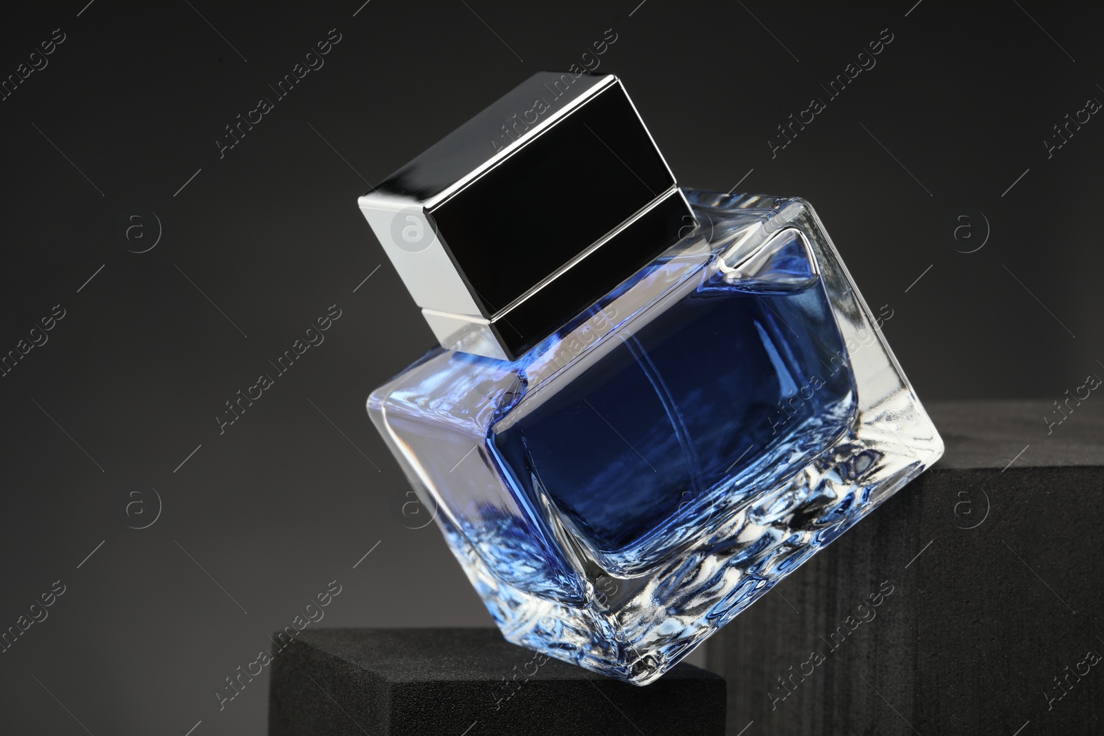 Photo of Luxury men`s perfume in bottle against grey background, closeup