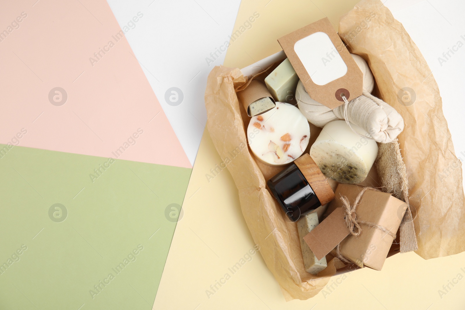 Photo of Box with eco friendly personal care products on color background, top view. Space for text