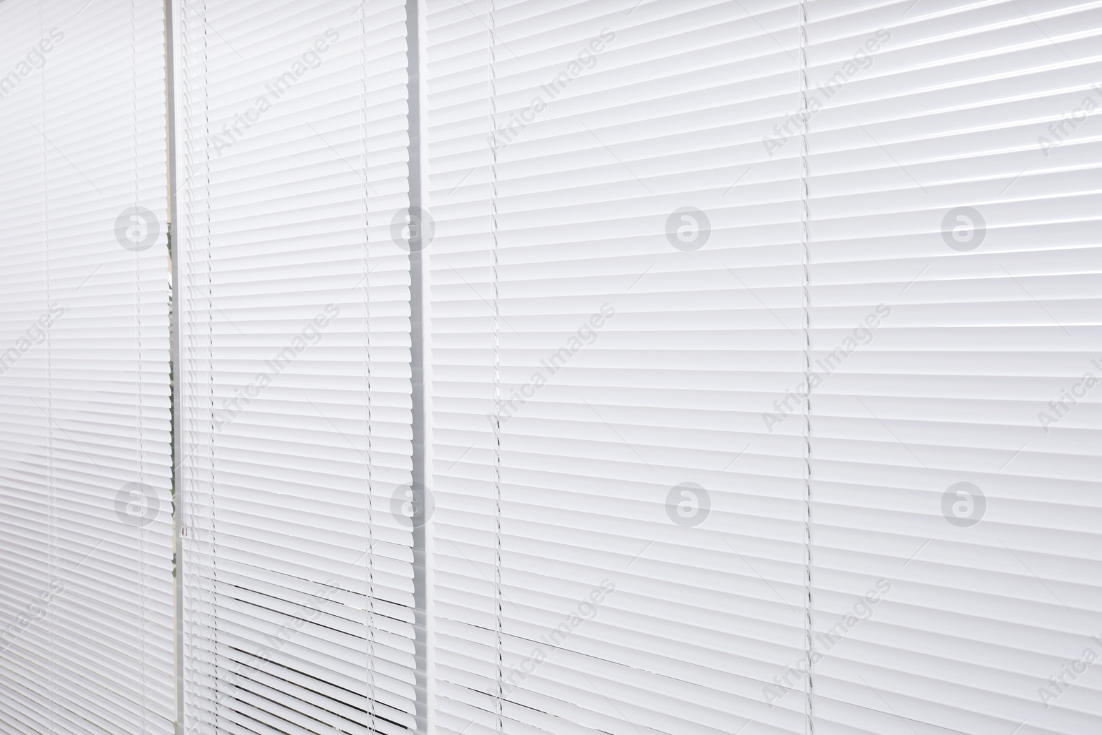 Photo of Window with closed white horizontal blinds as background