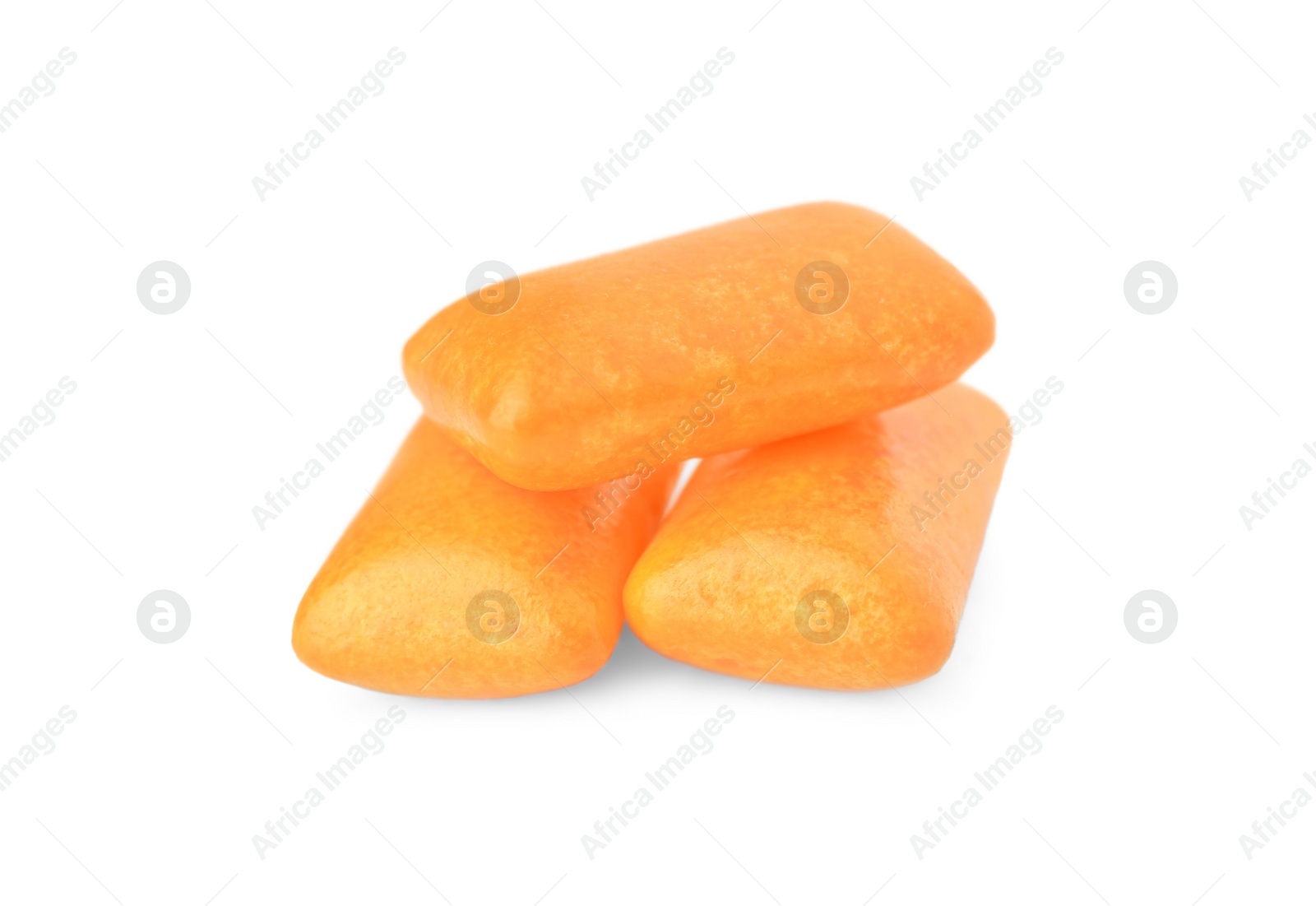 Photo of Tasty orange chewing gums isolated on white