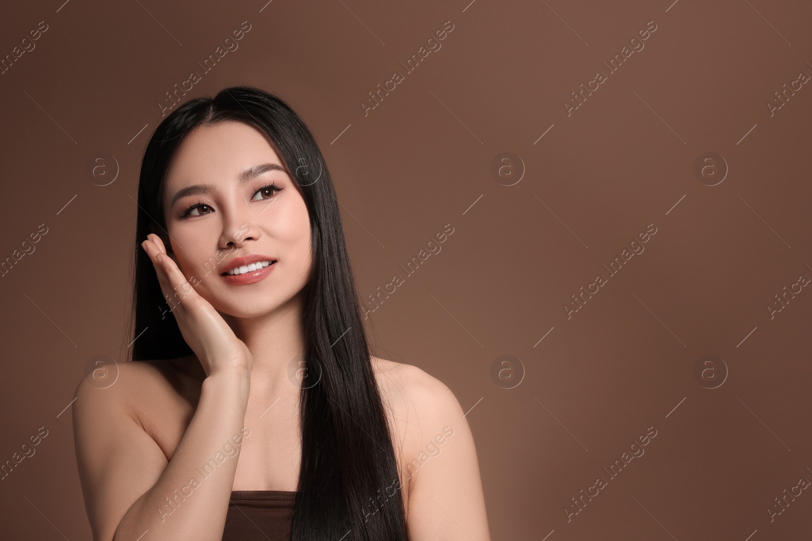 Photo of Portrait of beautiful woman on brown background, space for text