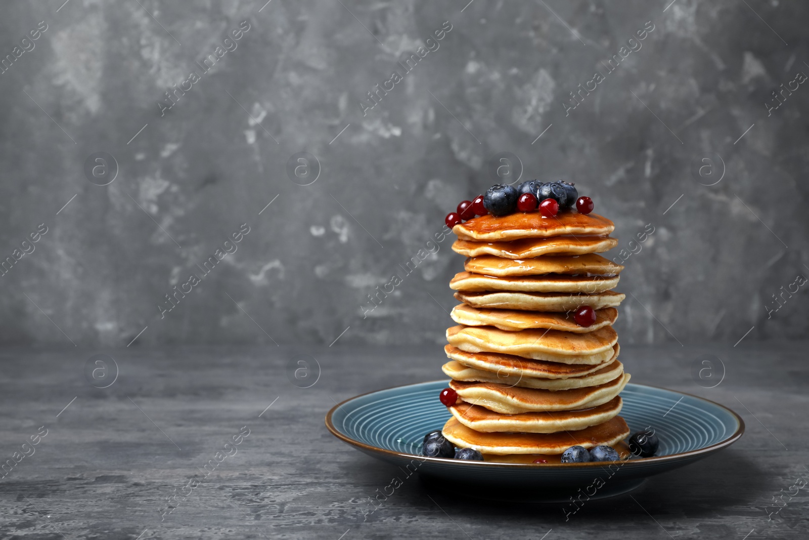 Photo of Tasty pancakes with berries on table