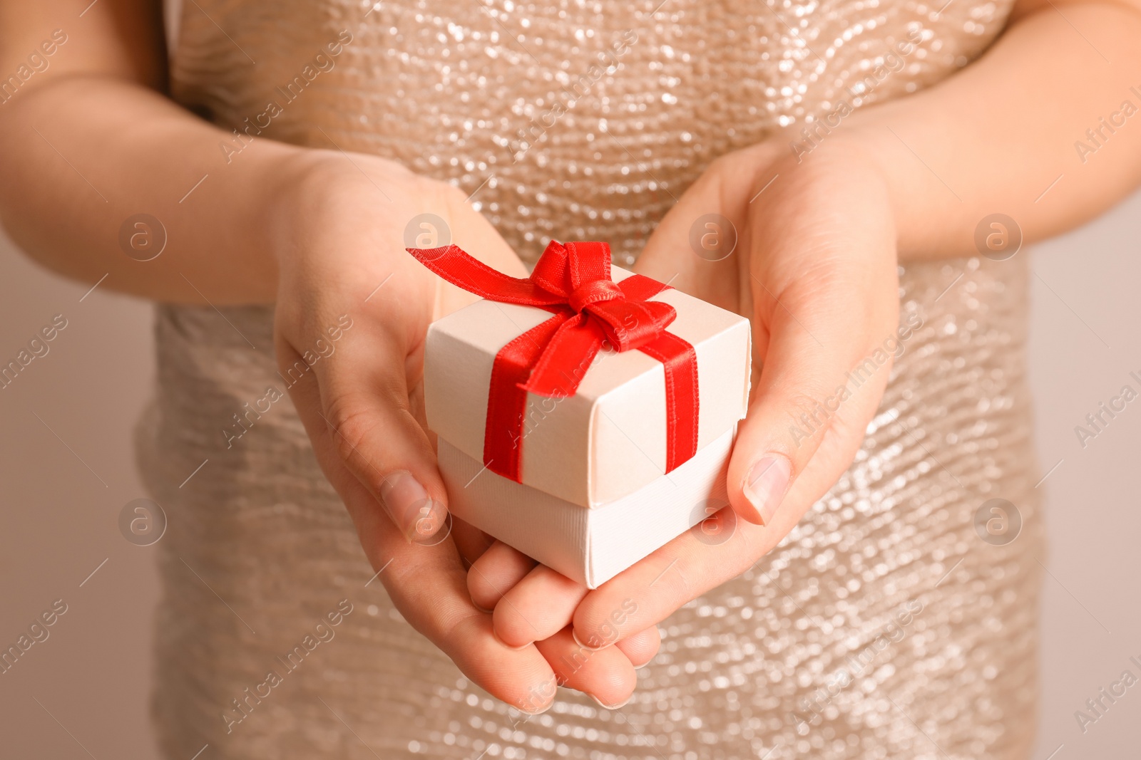 Photo of Woman holding beautiful gift box, closeup