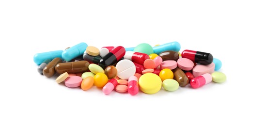 Photo of Heap of different colorful pills isolated on white
