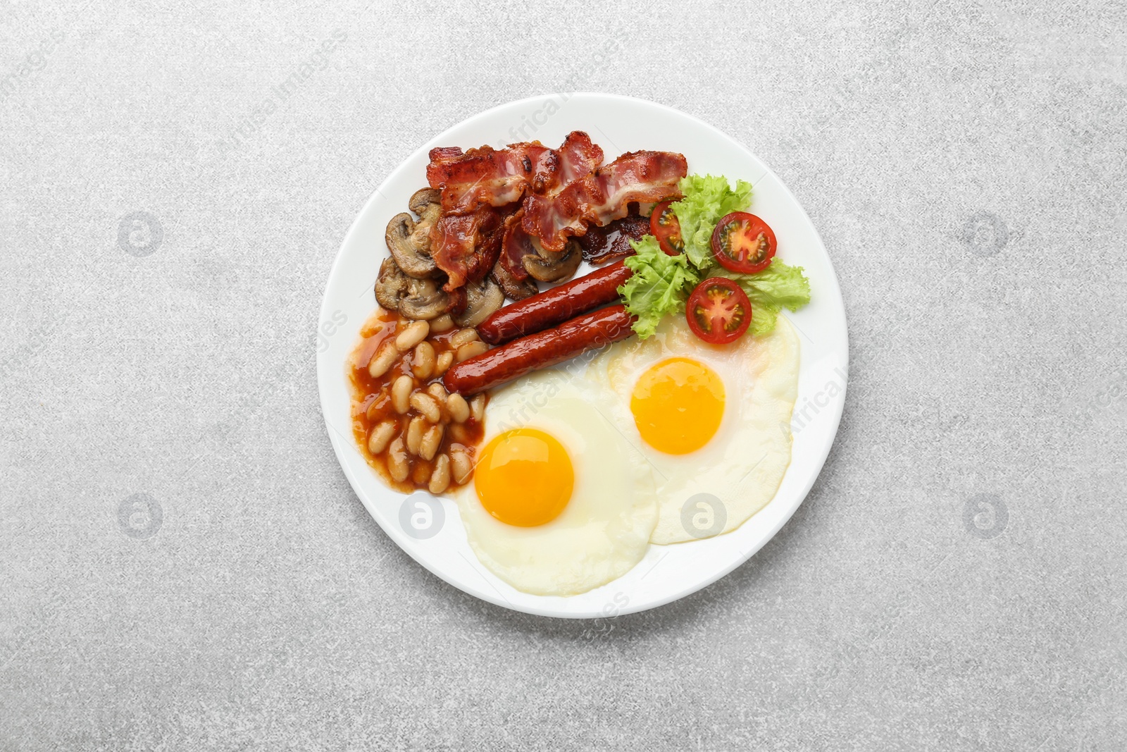 Photo of Delicious breakfast with sunny side up eggs on light table, top view